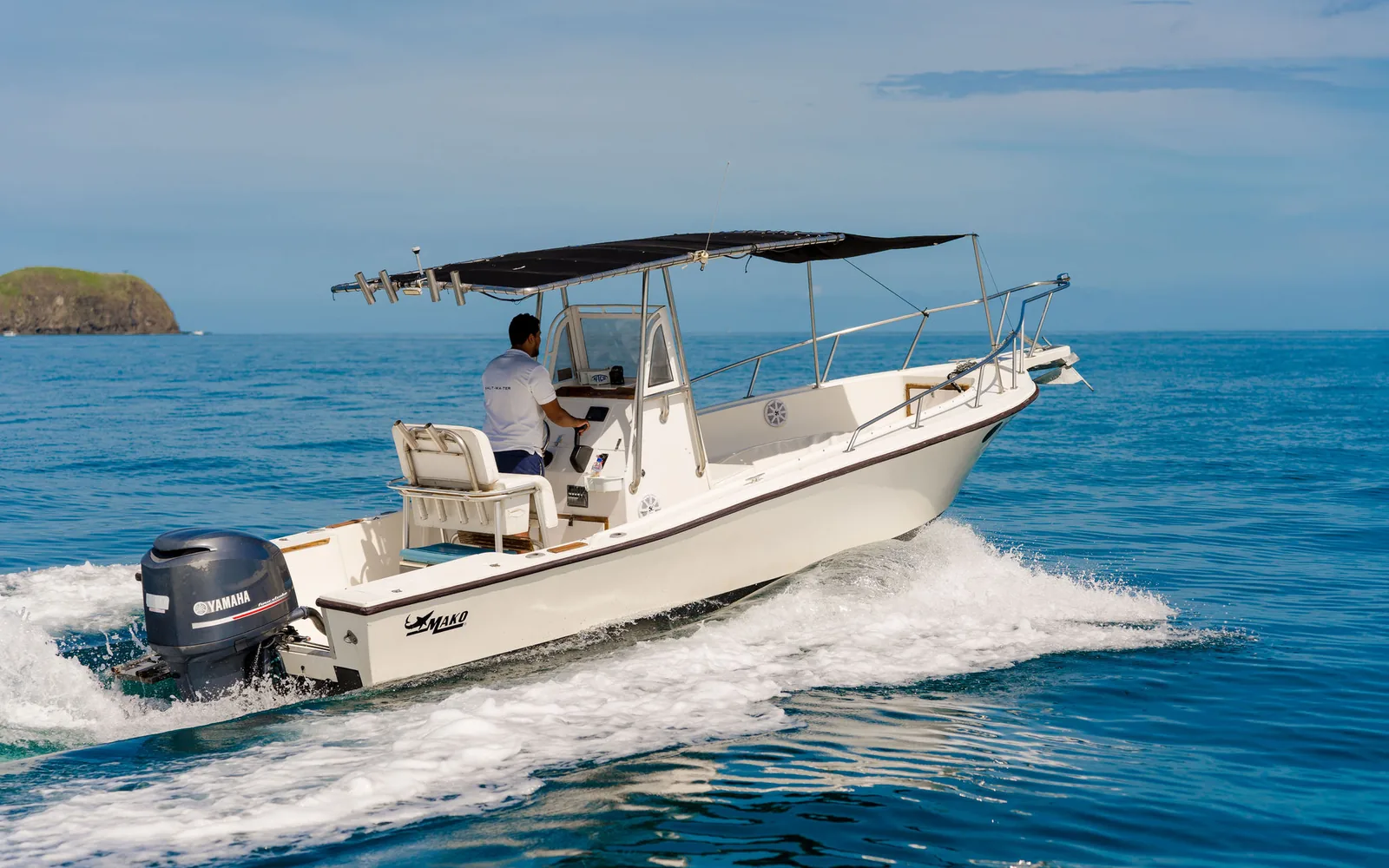 An Ocean Club center console fishing boat with T-top running on Ocean Club off Guanacaste, Costa Rica